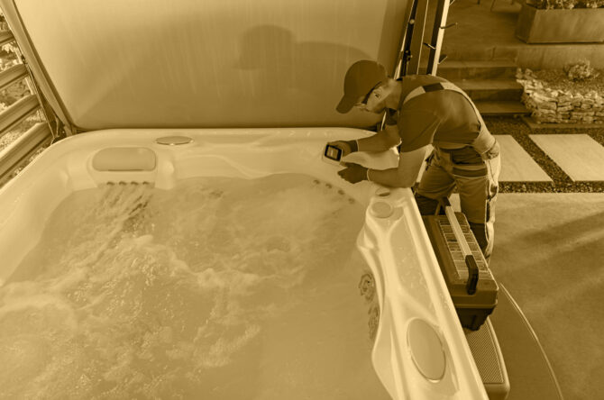 Caucasian Hot Tub Professional Technician in His 40s Checking on System Controller Under Modern Residential Gazebos. Home Recreation Theme.